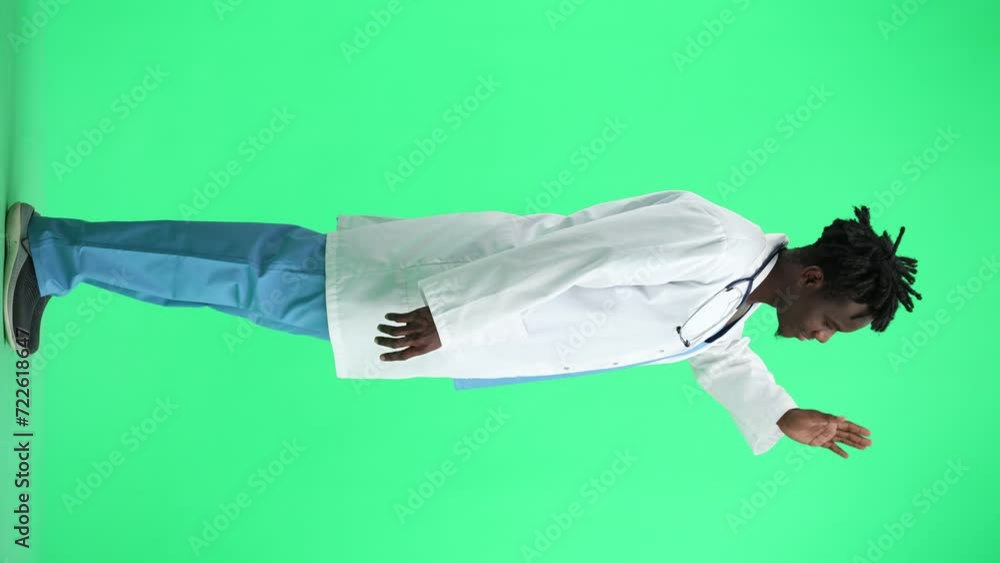The doctor, in full height, on a green background, waving his hand The doctor, in full height, on a green background, waving his hand