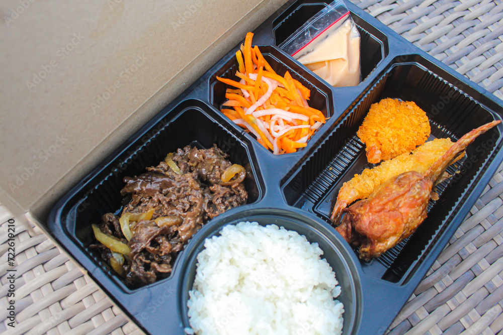 Indonesian Bento box containing rice, beef teriyaki, salad and dressing ...