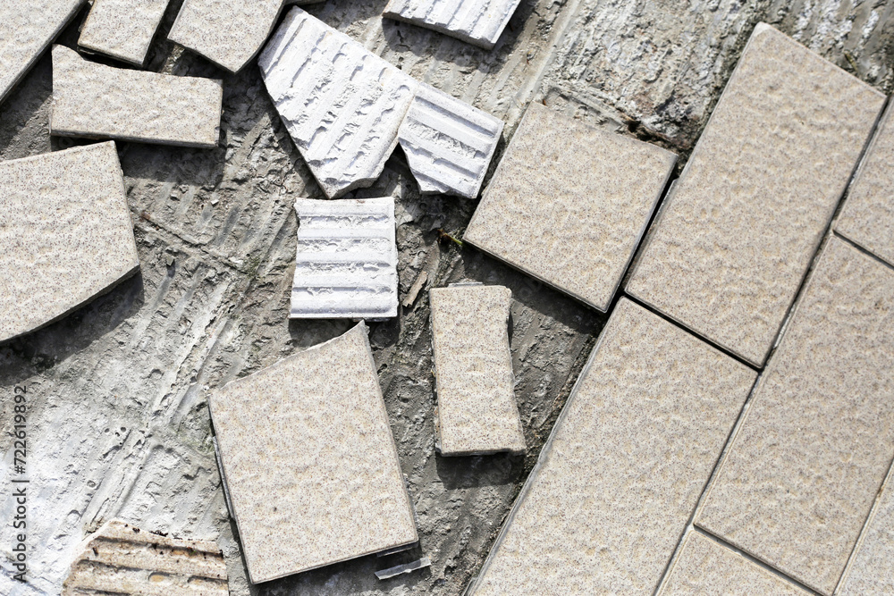 Cracked brown tiles on cement floor Cracked brown tiles on cement floor