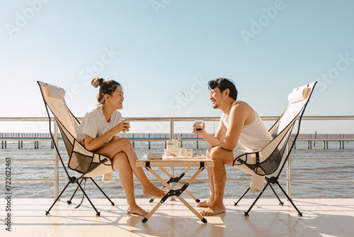 Asian couple lover enjoy their holiday at the sea in the summer with beautiful clear sky ocean. © Sevendeman