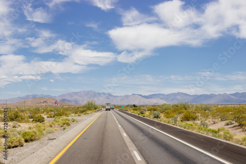 Beautiful blue sky with fluffy clouds over the highway. Scenic road in Arizona, USA on a sunny summer day. 40 hwy, 10 hwy in Arizona, USA - 17 April 2020 © Liudmila