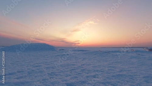 Sunset over a frozen lake in winter