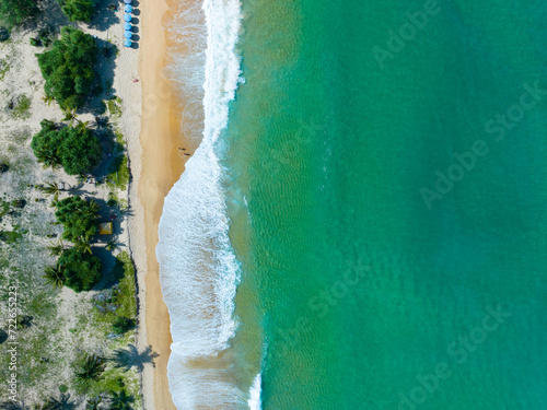 Aerial view of Waves crashing on sandy shore,Sea surface ocean waves background,Top view beach background