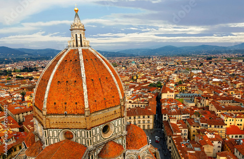 The majestic dome of Cathedral Santa Maria del Fiore overlooks the old town of Florence~Florence's cathedral stands out in the city with its beautiful Renaissance dome designed by Filippo Brunelleschi photo