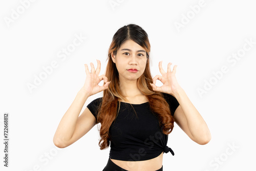 Young asian woman long hair style in black t shirt posing hand ok sign looking camera isolated on white background.