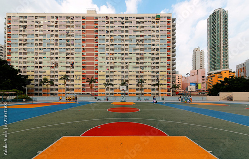 Crowded narrow apartments in the building of Choi Hung public housing estate in Kowloon, Hong Kong, with a basketball stand in the court, a phenomenon of severe housing shortage in Hongkong