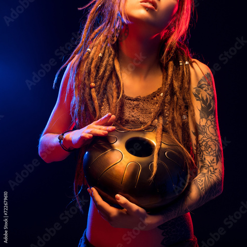 Girl with henna bodyart holding a hapi drum view photo