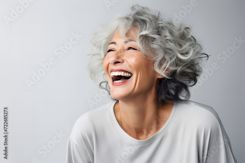 middle-aged woman in her 40s, with white gray hair, smiling beautifully as a skin care product model photo