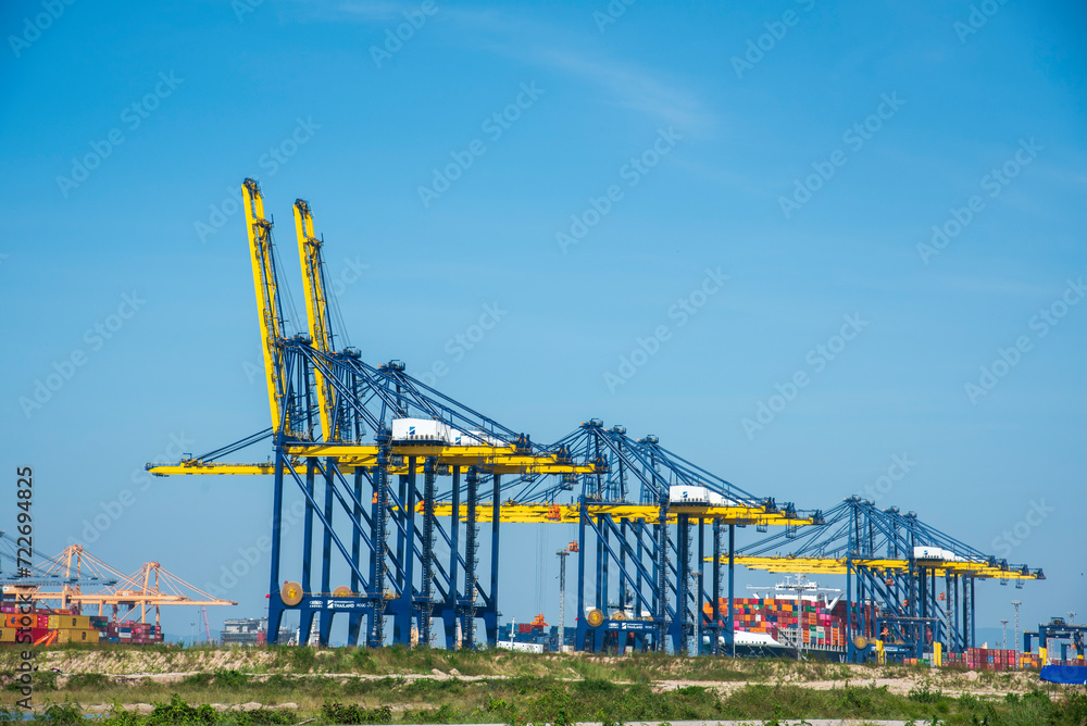 Engineering shipping crane depot at logistic export terminal control. Warehouse freight background container yard loading quayside harbor port. Logistics seascape shipping portal concept Engineering shipping crane depot at logistic export terminal control. Warehouse freight background container yard loading quayside harbor port. Logistics seascape shipping portal concept