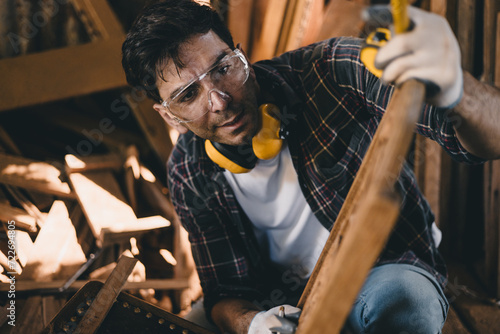 professional carpenter man hand working make wooden handcraft furniture master workpiece fine detail artisan with wood workshop. photo