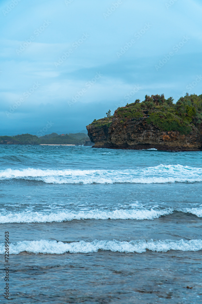 The blue sea and coral in the middle of the sea and the horizon line that separates the sea from the sky. The vast ocean at the tip of Java Island, Indonesia