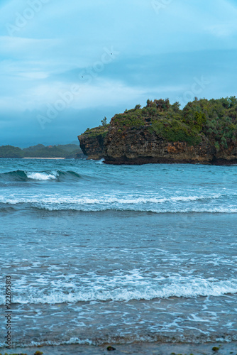 The blue sea and coral in the middle of the sea and the horizon line that separates the sea from the sky. The vast ocean at the tip of Java Island, Indonesia