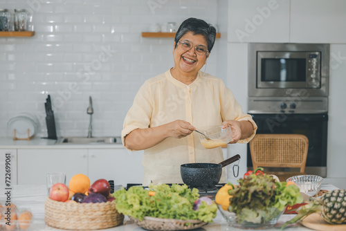 Senior Asian People elder happy living in home kitchen. Elderly cooking in a kitchen. Happy mature man and woman in the kitchen, Active seniors. Older people relationship and activity