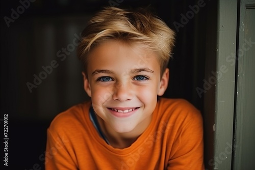 Portrait of a smiling boy with blue eyes looking at the camera