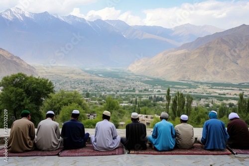people sitting on a carpeted area overlooking a breathtaking view of a valley