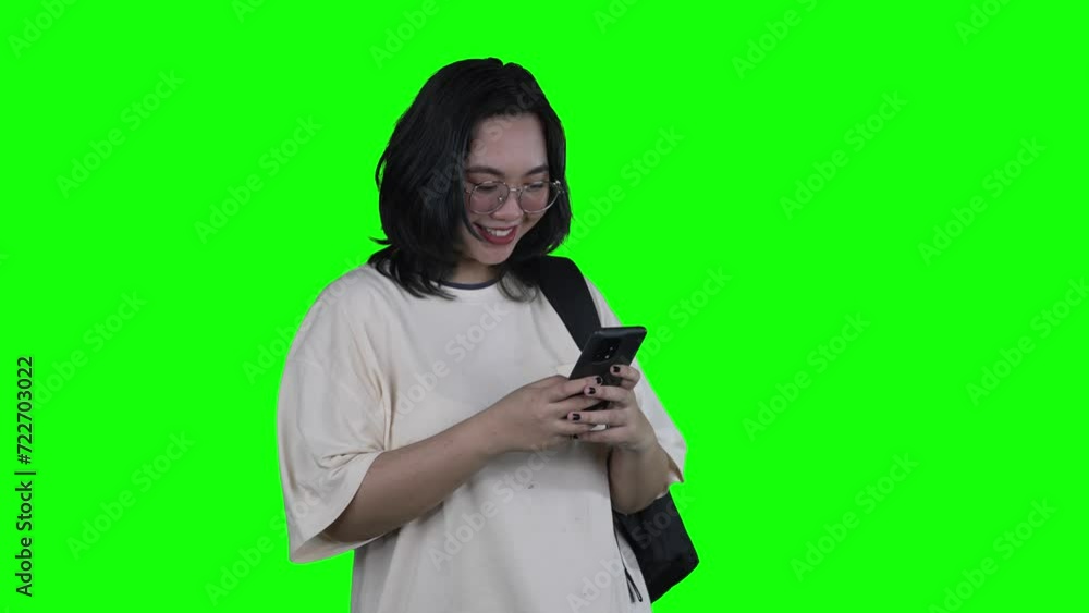 Happy Asian woman laughing while chatting on mobile phone Happy Asian woman laughing while chatting on mobile phone