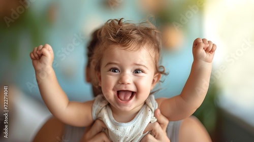 Happy Child with Two Raised Fists while Father Holding Up