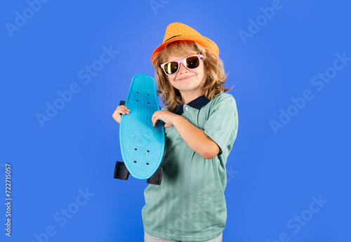 Kid with skateboard. Child hold skate board. Healthy sport and activity for school kids in summer. Sports fun.