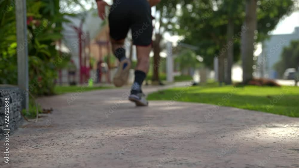 Slow motion of a shirtless man running sprinting away from the camera getting progressively out of focus Slow motion of a shirtless man running sprinting away from the camera getting progressively out of focus
