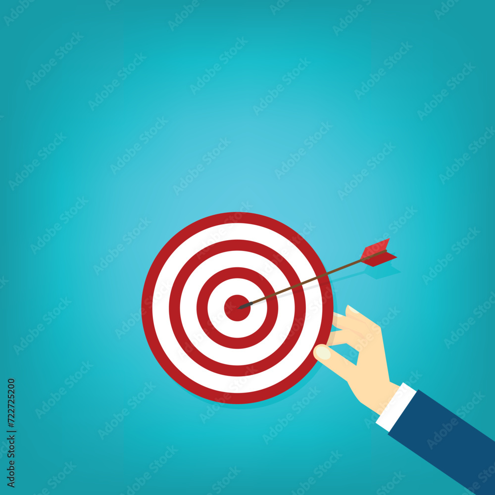 Hand holding a target, showing a goal. Red arrow hits the center. Business challenge failure and success concept. Hand holding a target, showing a goal. Red arrow hits the center. Business challenge failure and success concept.