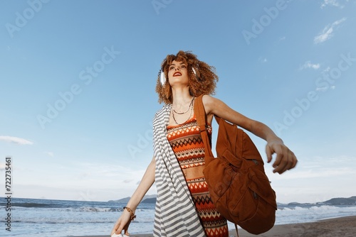 Summer Freedom: Smiling Woman on Beach Vacation, Enjoying the Sea and Nature Bliss, Close-up with Curly Hair, Freckles, and Joyful Emotion