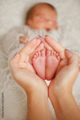 heels of a newborn baby. children's feet in mother's hands. tenderness. newborn baby. baby's heels. newborn photo session. youngest daughter. happiness. mother. 
heels of a newborn baby. Child's feet