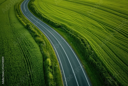 a highway in a green wheat field Aerial view photo