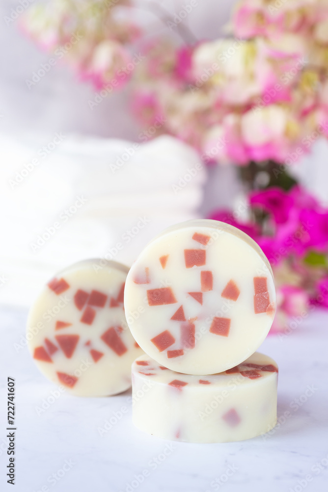 handmade natural soap bars, handmade rose clay soap on white background with pink flowers.