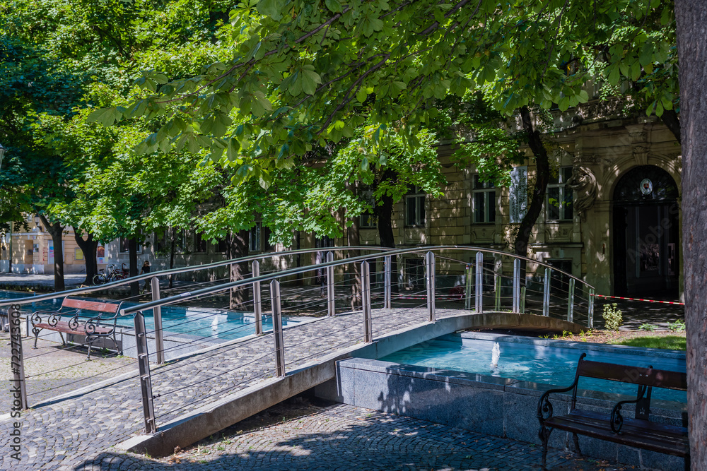 Pedestrian bridge over fountain pool in popular park in Bratislava, Slovakia.