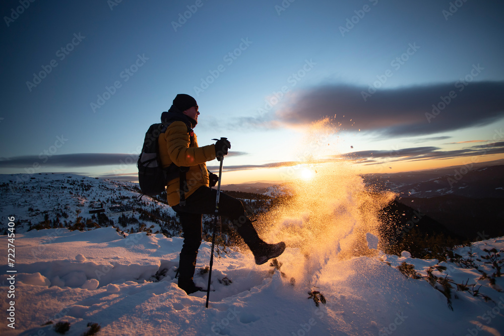 Fototapeta premium Hiker in a wintry mountain landscape