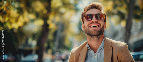 Smiling man in sunglasses on a sunny day.