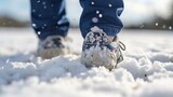 Close-up of a man's feet in sneakers on the snow