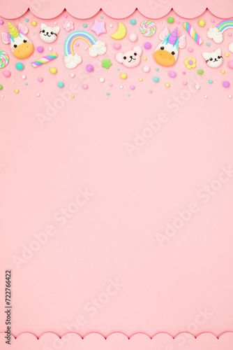 Trendy pastel pink kawaii background with cute air plasticine handmade cartoon animals, unicorns, stars, rainbows pattern border. Top view, flat lay, copy space. Candycore, fairycore. photo