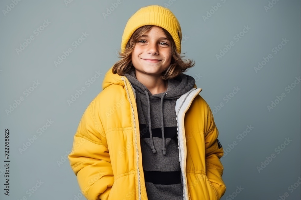 Portrait of a cute young boy in a yellow jacket and hat Portrait of a cute young boy in a yellow jacket and hat