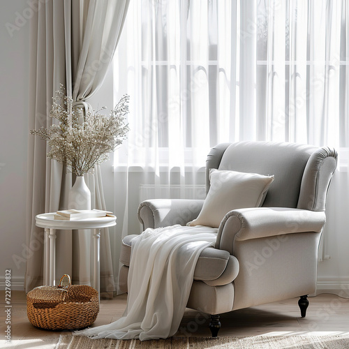 Cozy soft grey armchair next to the window decorated with white curtains