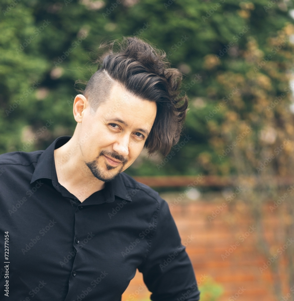 Portrait of smiling man in black shirt