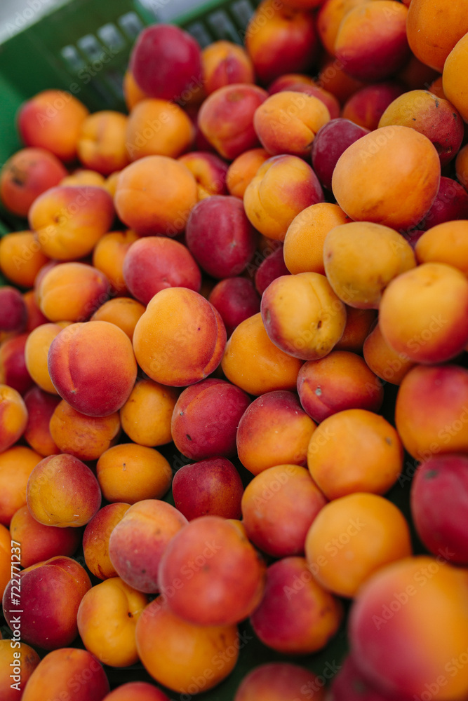 Large apricots lie in a box on the counter Large apricots lie in a box on the counter