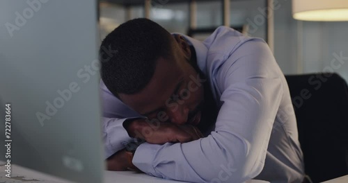 Businessman, sleeping and night by laptop in office, professional burnout and tired by desk in workplace. Black person, corporate and fatigue with rest at company computer and overtime by online work photo