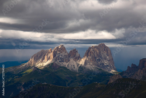 The three peaks of the Sassolungo (Langkofel) with dramatic sky in the Dolomites, Italy.