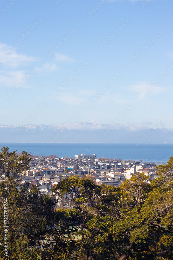 Looking to the city of Hikone from Hikonejo (Hikone Castle) in morning in Winter, Shiga Prefecture, Japan. Vertical image