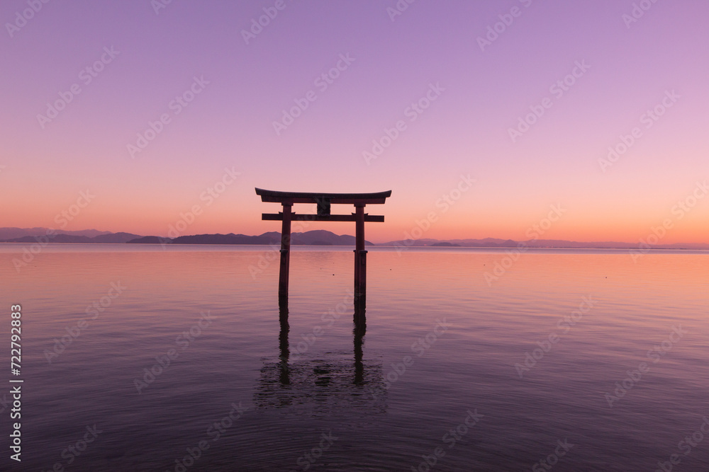 Beautiful dusk of a grand torii gate at Lake Biwa (Biwako), Takashima, Shiga, Japan. Silhouette. Copy space