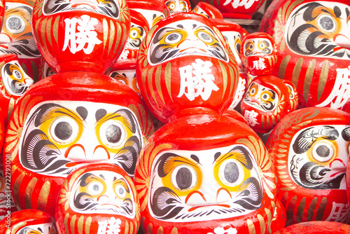 Many red daruma dolls or dharma dolls in Katsuo-ji temple. The Kanji translated to English : 'Victory'. photo