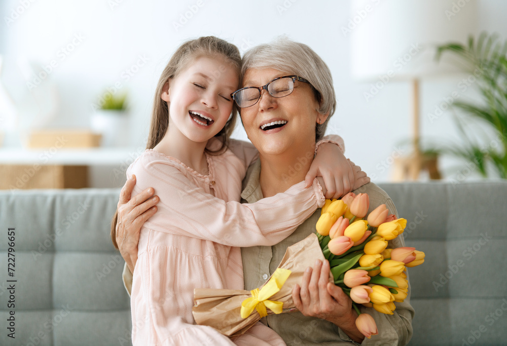 Grandma and girl smiling and hugging