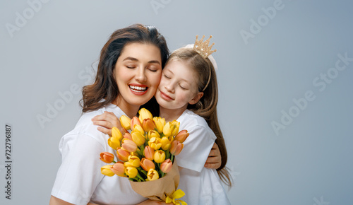 Daughter and mother with bouquet of flowers