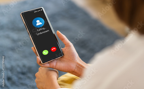Human use smartphone with incoming call from unknown number, spam, prank caller, hoax person, fake identity, scammer, scam with mobile phone, hacker, call center, crime, call, fraud or phishing 