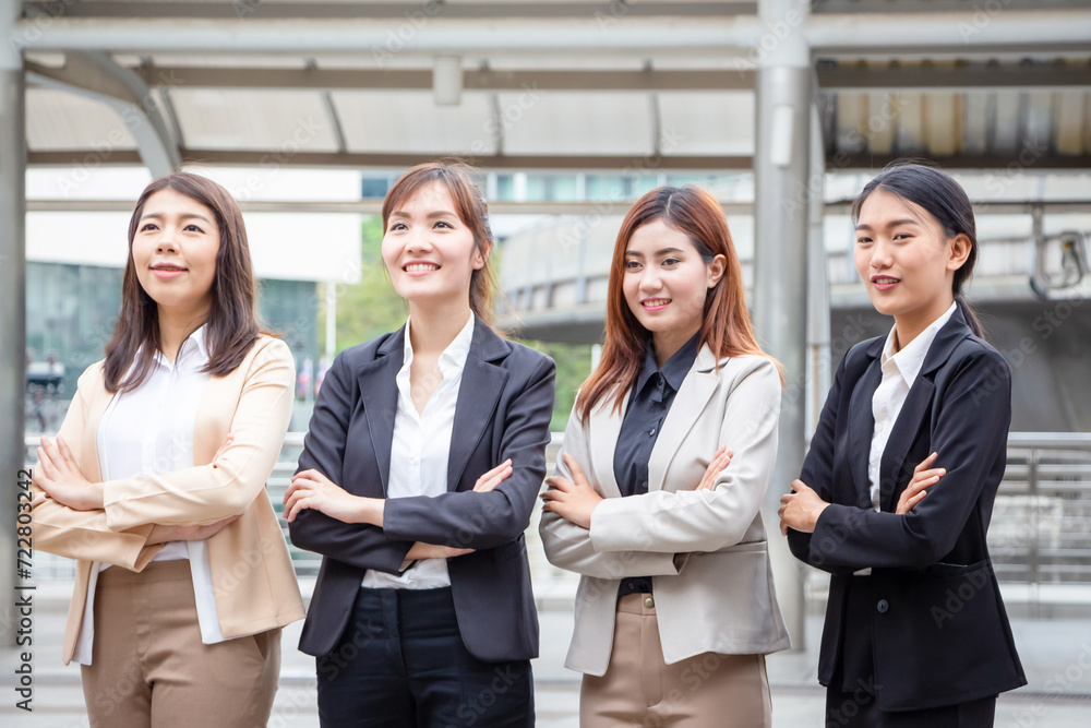 Business people standing with arms crossed, Young Asian women team standing with arms crossed blurred city background Business people standing with arms crossed, Young Asian women team standing with arms crossed blurred city background
