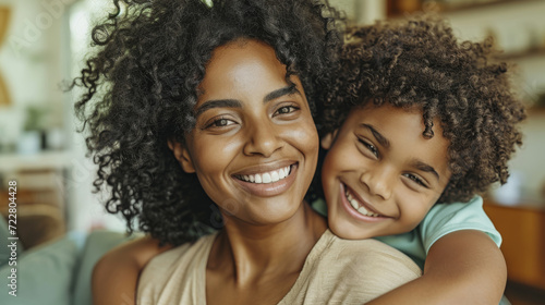 smiling woman and a young girl with curly hair