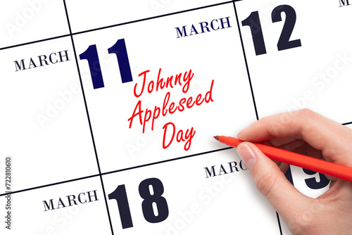 March 11. Hand writing text Johnny Appleseed Day on calendar date. Save the date. photo