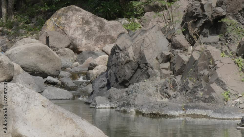 Small river that flows gently between large rock formations during the summer in the town of the municipality of Soledad in Honduras. Small river that flows gently between large rock formations during the summer in the town of the municipality of Soledad in Honduras.