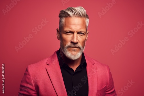 Portrait of a serious mature man in a pink suit. Men's beauty, fashion. © Loli